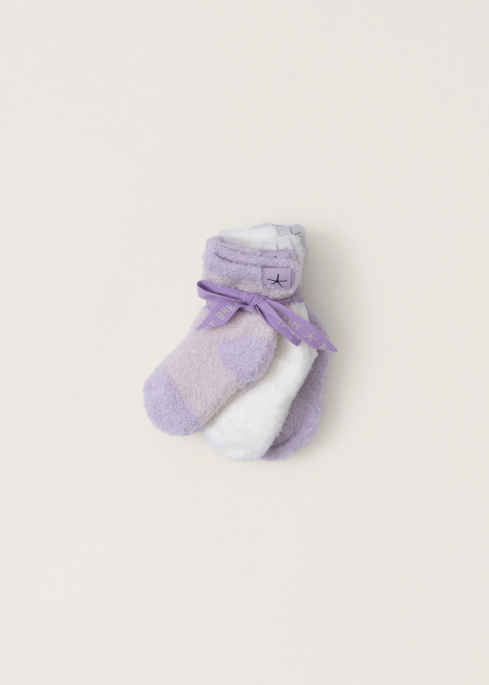A three pack of white and lilac infant socks bundled together and laying on a white background