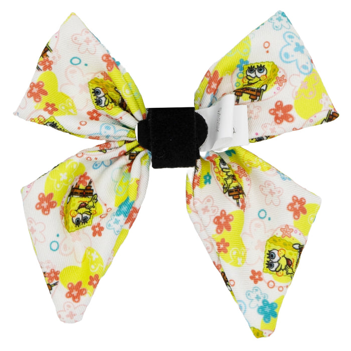 The Sassy Woof Dog Sailor Bow - SpongeBob SquarePants™ Bikini Bottom is a white bow with colorful flowers, SpongeBob graphics, a black center band, and a small tag—ideal to pair with matching SpongeBob harnesses or collars.