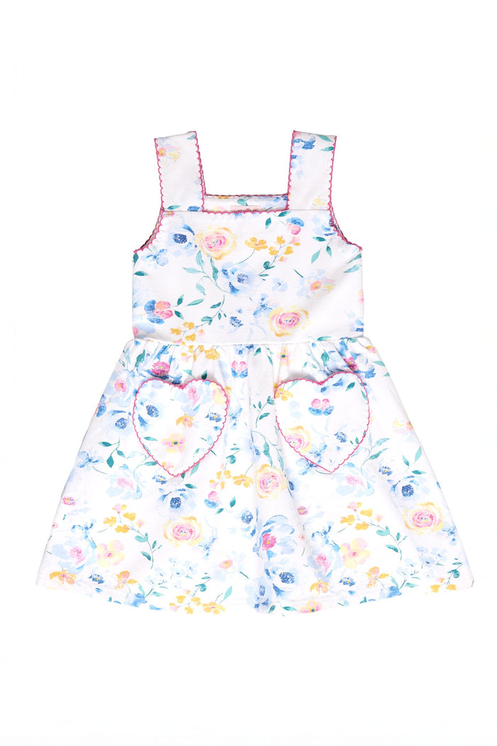 The Mini Rue Play Dress in Blue Bouquet by Ivy City Co is a sleeveless dress for girls, featuring a vibrant blue floral print, pink trim, and two heart-shaped pockets on the skirt, displayed on a white background.