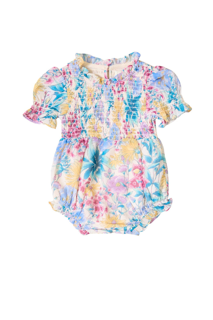 The Baby Cordelia Romper in Pretty Plumeria by Ivy City Co features puff sleeves, a round neckline, and a stretchy smocked bodice. Adorned with a vibrant Pretty Plumeria print in pink, yellow, blue, and green hues, this charming spring romper includes gathered leg openings and a convenient back button closure.