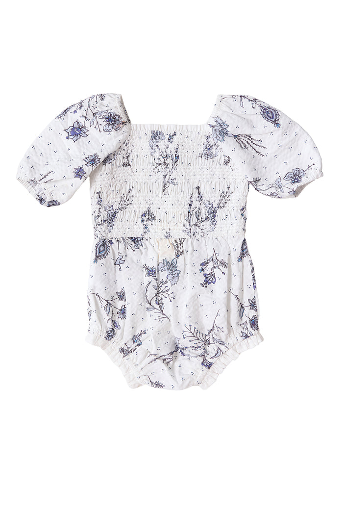The Ivy City Co Baby Roselyn Romper in Blue Enchanted Floral features short puff sleeves, smocked chest detailing, elasticized leg openings, and is part of a Mom & Me set.