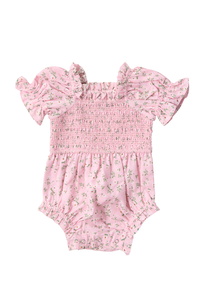 The Ivy City Co Baby Valencia Romper in Pink Ditsy Floral features ruffled sleeves, a smocked bodice, elastic gathers, and bottom snap closures for easy changing.