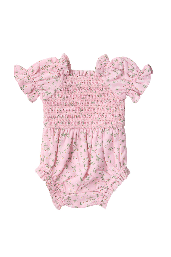 The Ivy City Co Baby Valencia Romper in Pink Ditsy Floral features ruffled short sleeves, a shirred bodice, and elastic leg openings—making it a charming choice for your little one.