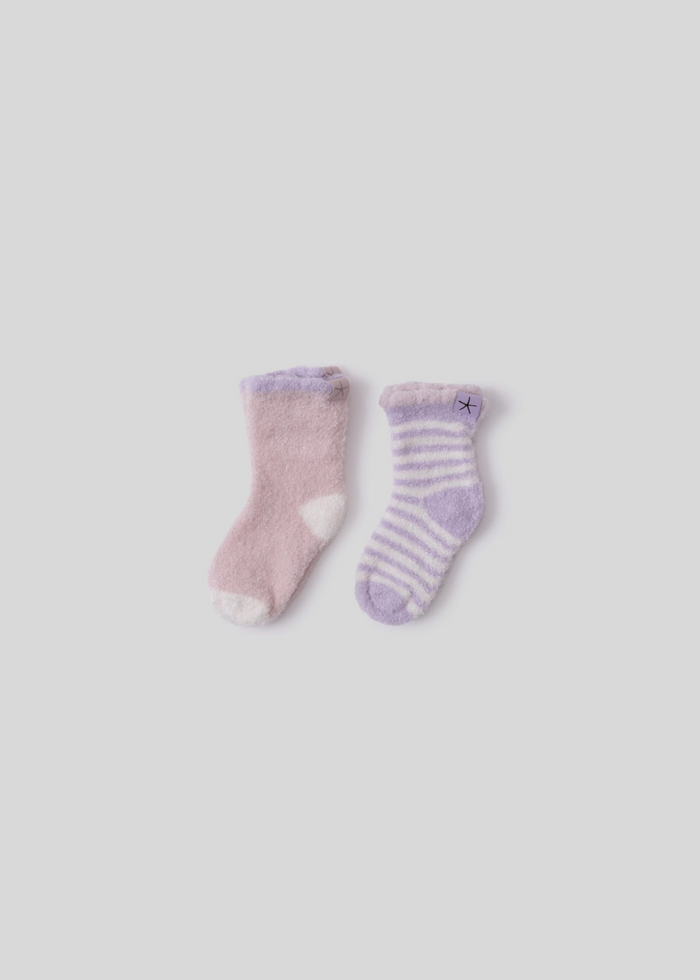 A pink sock with purple and white details laying next to a purple sock with white stripes, both laying on a white background