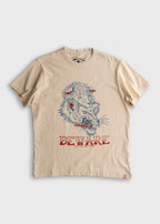 Beige T-shirt with a fierce wolf illustration and "BEWARE" text in red. Iron & Resin logo inside the collar.