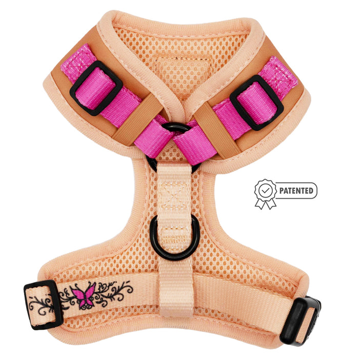 The Sassy Woof Dog Adjustable Harness - Bikini Bod features peach and pink mesh, black buckles, floral embroidery, adjustable straps, a patented side label, and is part of our Puppy Growth Pawtection Plan.