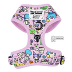 The Sassy Woof Dog Adjustable Harness – Hello Kitty® & Friends Flower Festival features a pastel pink design with colorful characters, black buckle, adjustable straps, brand labels, and a patented badge beside this stylish dog harness.