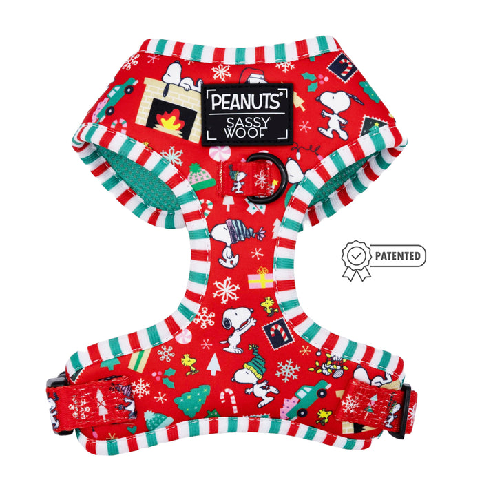 The Sassy Woof Dog Adjustable Harness - Peanuts™ Beagle Bells features festive red with Snoopy and holiday motifs, candy cane striped edges, a center PEANUTS Sassy Woof label, and Patented badge—ideal for any Snoopy dog harness fan!.
