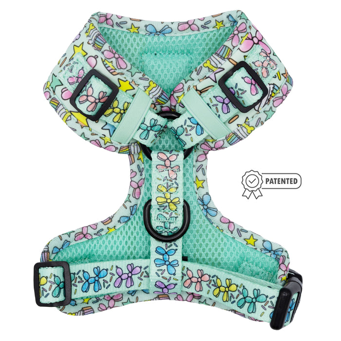 The Sassy Woof Dog Adjustable Harness - Pup Pup Hooray features a light blue design with colorful butterflies, stars, stripes, black buckles, metal D-ring, and patented icon—ensuring comfort and style for your growing pup.
