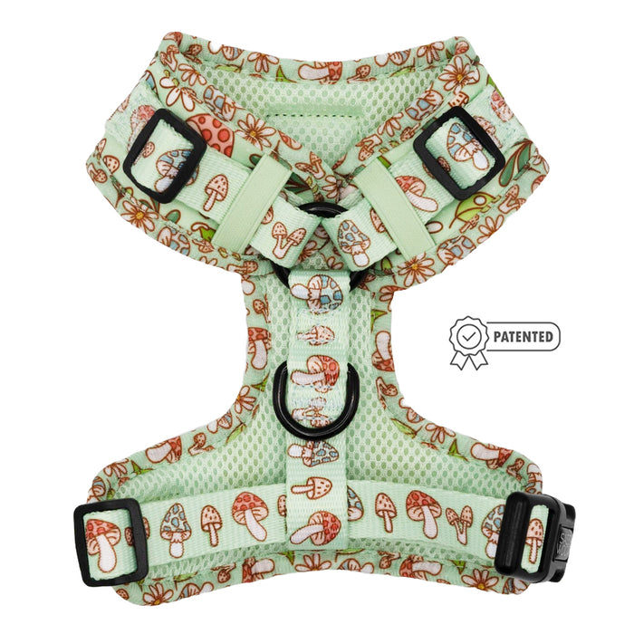 The Sassy Woof Dog Adjustable Harness - Shrooms & Blooms features light green mesh with red and white mushrooms, flowers, adjustable black buckles, and a patented symbol on the right side.