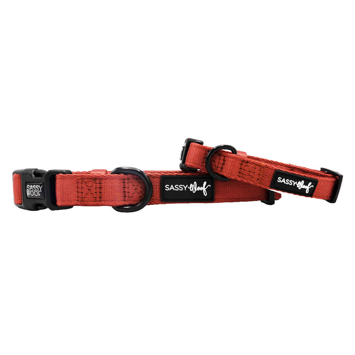 Two Sassy Woof Dog Collar - Burgundy are shown parallel on a white background. Each adjustable collar features black plastic buckles and rings, soft neoprene material, and a small black Sassy Woof label for style.