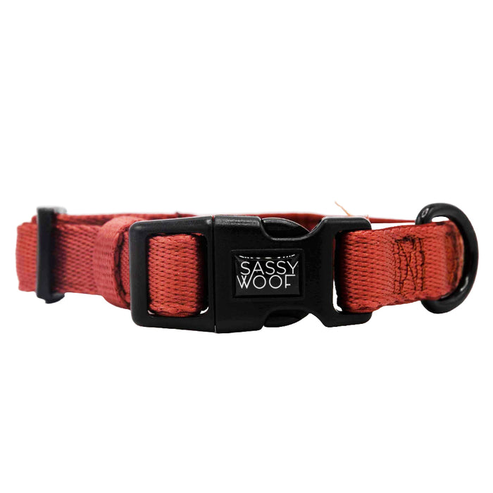The Sassy Woof Dog Collar - Burgundy features an adjustable fit, black plastic buckle with the Sassy Woof logo, metal ring, and is made of durable neoprene for your pup’s comfort.