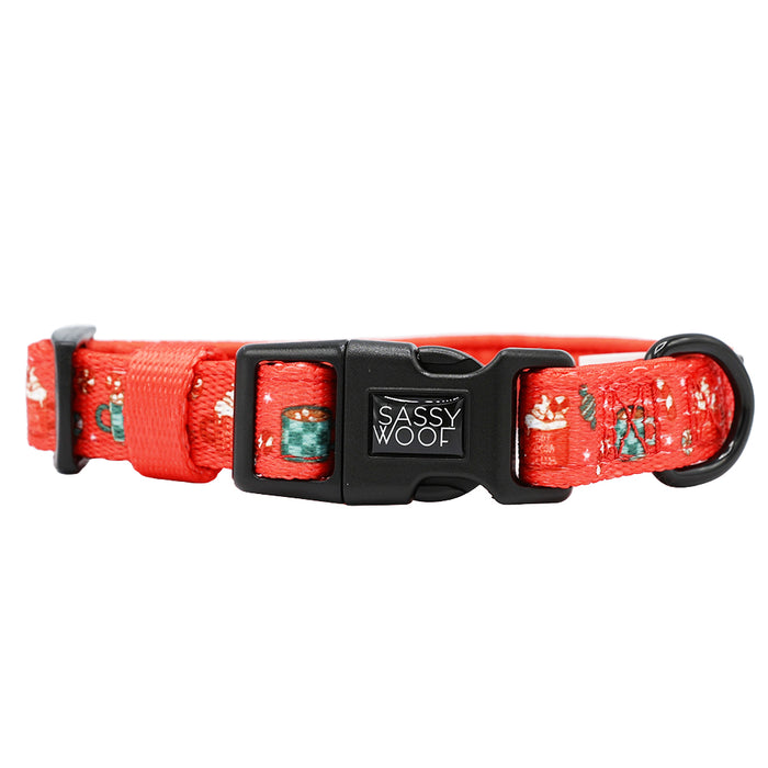 The Sassy Woof Dog Collar - Hot Cocoa Club is a red adjustable collar with black plastic buckle, playful tents and animals pattern, and sturdy black D-ring for leash attachment.
