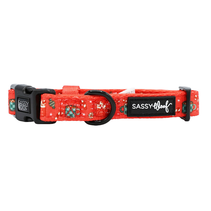The Sassy Woof Dog Collar - Hot Cocoa Club features an adjustable red floral design, black plastic buckle, metal D-ring, and the Sassy Woof label.