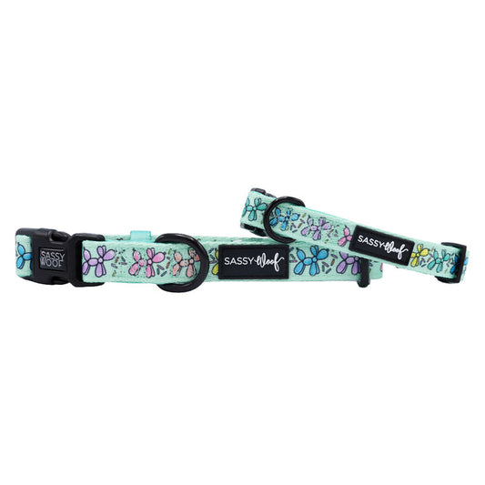 Two mint green Sassy Woof Pup Pup Hooray dog collars with black buckles and rings, featuring colorful pink, purple, and blue dragonflies. These neoprene collars blend comfort with style.