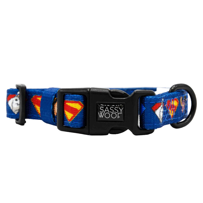 The Sassy Woof Dog Collar - Superman™ & Krypto™ features blue fabric with Superman graphics, a sturdy black buckle, and a metal D-ring—perfect for your super dog!.