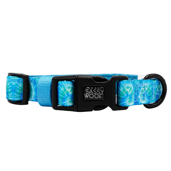 The Sassy Woof Dog Collar - Tropical Tides features an adjustable fit, black plastic buckle, branded label, and a turquoise and light blue tie dye design.
