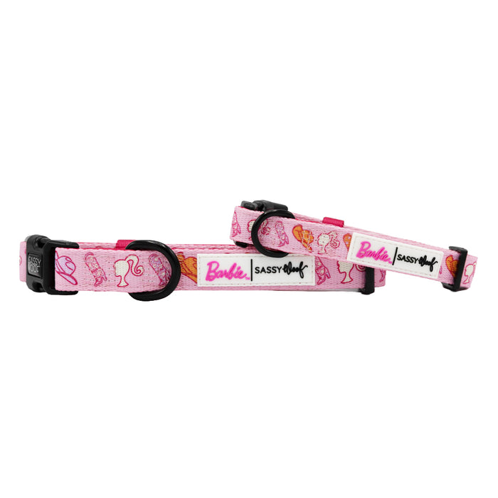 Two adjustable Sassy Woof dog collars featuring Western Barbie™ designs with Barbie heads, sunglasses, shoes, bows, and Western accents. Equipped with black plastic buckles and metal D-rings for style and durability.