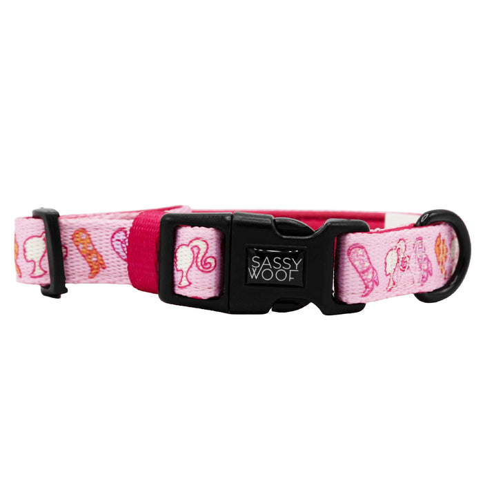 The Sassy Woof Dog Collar - Western Barbie™ is a pink adjustable collar with Barbie head silhouettes, chic profile graphics, and a black plastic buckle—perfect stylish flair for your pup.