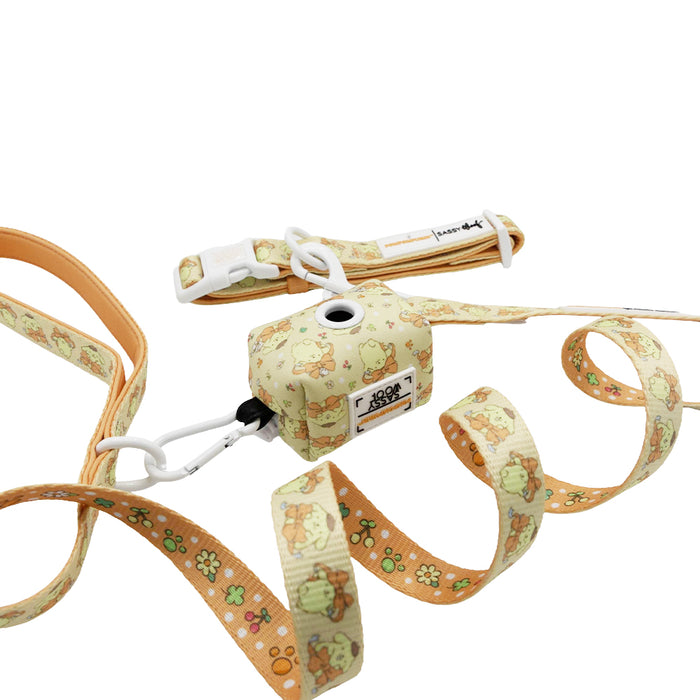 A light orange Dog Collar Three Piece Bundle - Pompompurin™ by Sassy Woof, featuring playful cartoon animal and flower patterns, includes a matching waste bag holder and a white clasp—all beautifully displayed against a white background for Sanrio fans who adore cute dog accessories.