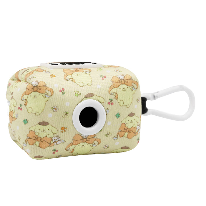A compact, cube-shaped pouch from Sassy Woof’s Dog Collar Three Piece Bundle - Pompompurin™, featuring an adorable yellow Pompompurin-inspired print, a black circular opening on one side, and a white clip for easy carrying.