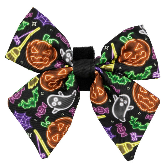 The Sassy Woof Dog Sailor Bow - Neon Frights features vibrant Halloween designs—orange jack-o’-lanterns, green bats, white ghosts, purple spider webs, and yellow brooms—perfect for your pup’s spooky season style.