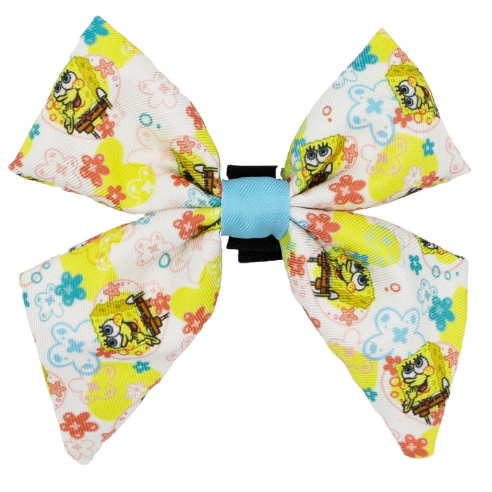 The Sassy Woof Dog Sailor Bow - SpongeBob SquarePants™ Bikini Bottom features a white bow with colorful flowers and SpongeBob images, tied with a light blue center band—perfect for pairing with other SpongeBob dog accessories.