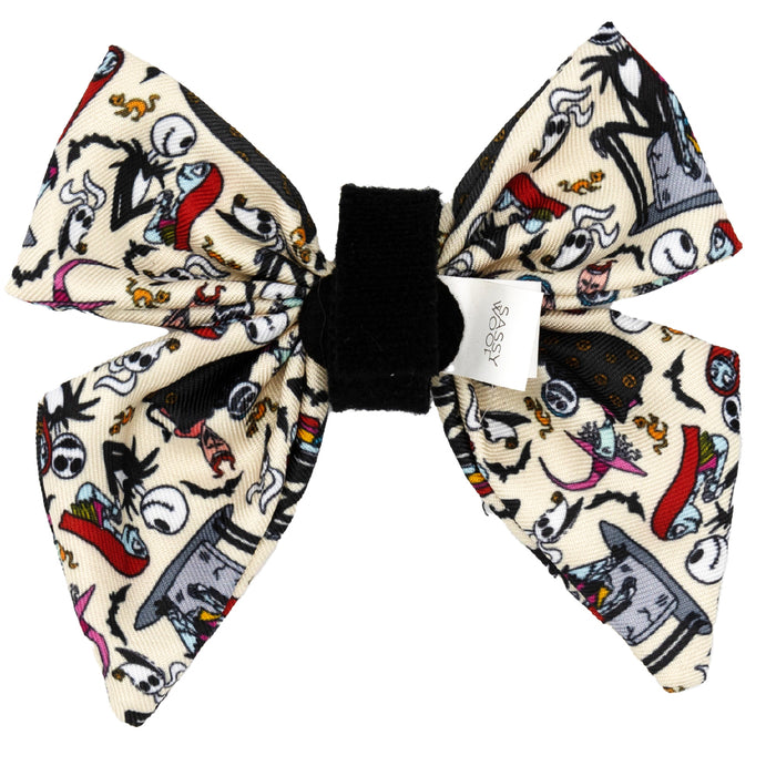The Sassy Woof Dog Sailor Bow – The Nightmare Before Christmas™ (Beige) features a black center and vibrant scenes from the film on a cream background—perfect for attaching to your dog’s collar or adjustable harness.