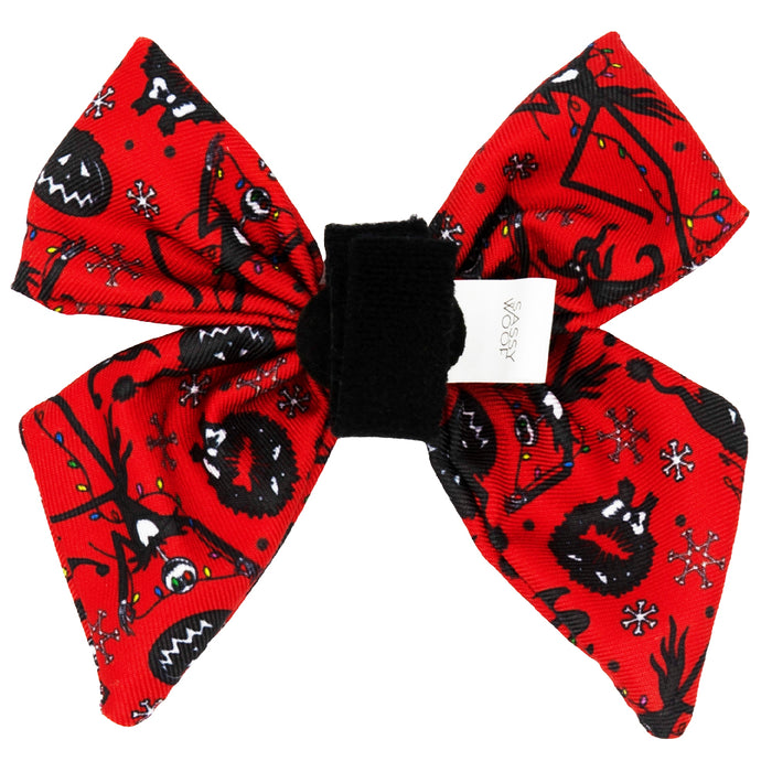 The Sassy Woof Dog Sailor Bow - The Nightmare Before Christmas™ (Red) features black cartoon monster faces, whimsical patterns, and white snowflakes on red fabric. Gathered with a black band, it includes a white tag attached.