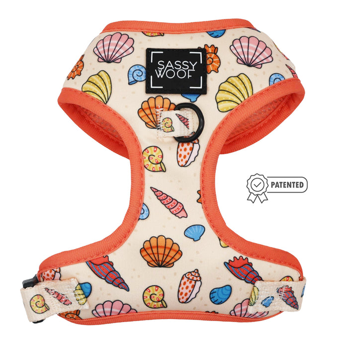 The Sassy Woof Dog Two Piece Bundle - Shell Yeah features a seashell pattern with orange trim, Sassy Woof chest logo, metal leash ring, and patented icon. This adjustable harness is ideal for beach-loving pups.