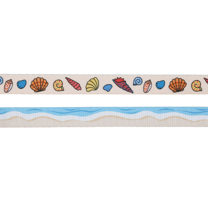 The Sassy Woof Dog Two Piece Bundle - Shell Yeah features a beige harness adorned with colorful seashells on top and blue wavy water with a sandy shore pattern below—ideal for stylish beach-loving pups.