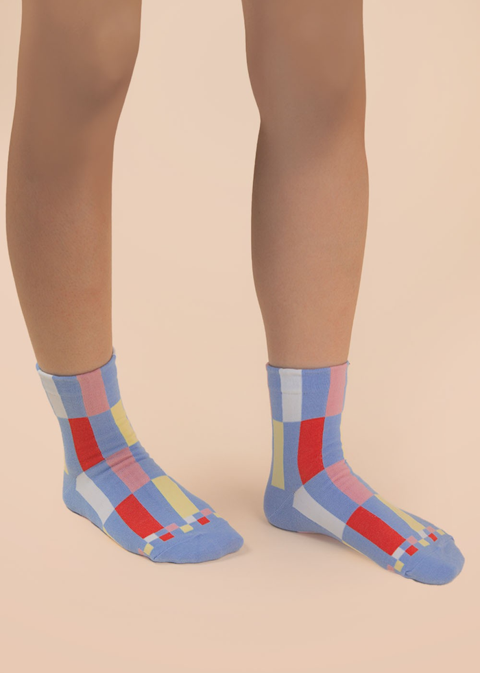 Person wearing blue and multicolor colorblock crew socks