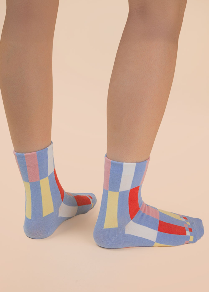 Person wearing blue and multicolor colorblock crew socks