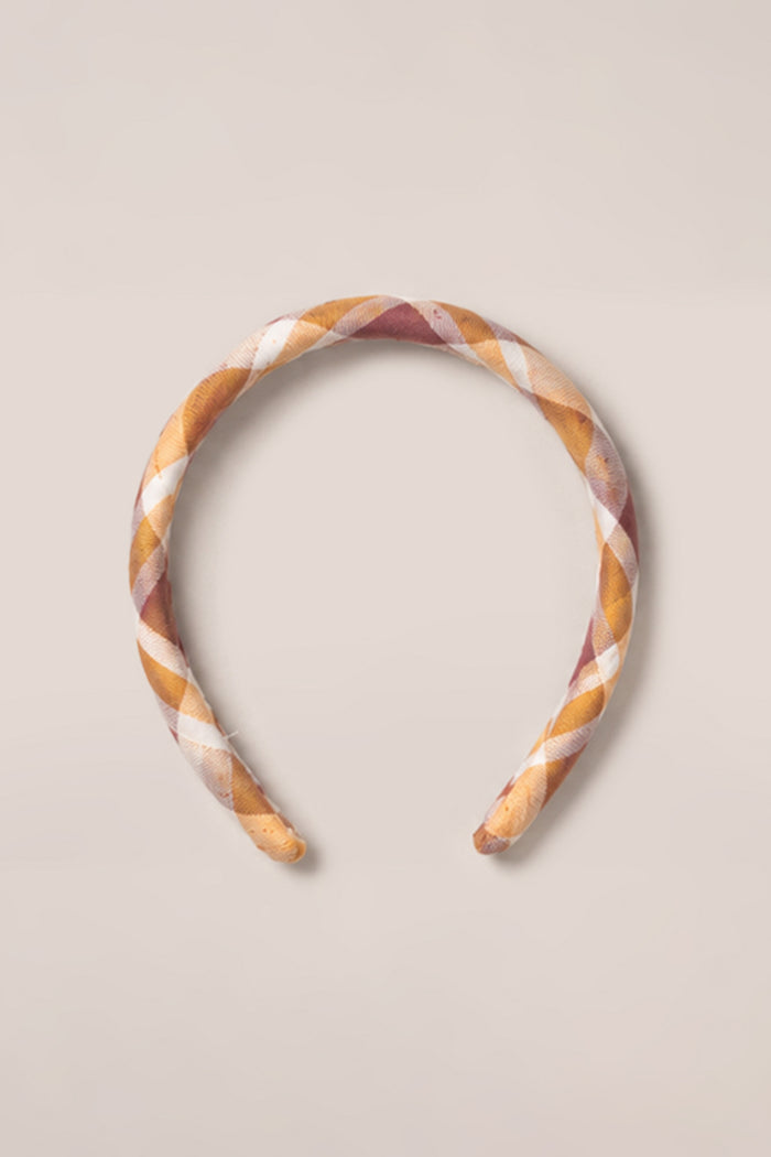 The Ivy City Co Hair Bows in Spiced Plaid, crafted from soft cotton and featuring a charming plaid pattern in shades of brown, tan, and white, are displayed on a plain light background to showcase their timeless style and comfortable design.