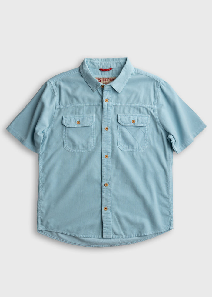 Light blue short-sleeve button-up shirt with two chest pockets and wooden buttons, displayed on a plain white background.