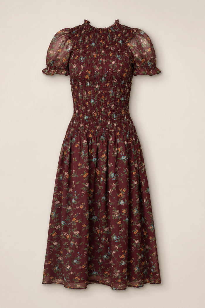 The Jennifer Dress in Aubergine Elysian Vine by Ivy City Co is a midi dress featuring a smocked bodice, puff sleeves with ruffle trim, and a flared skirt adorned with multicolor ditsy floral print on sheer fabric. Maternity friendly and effortlessly stylish, it provides both comfort and charm for any occasion.