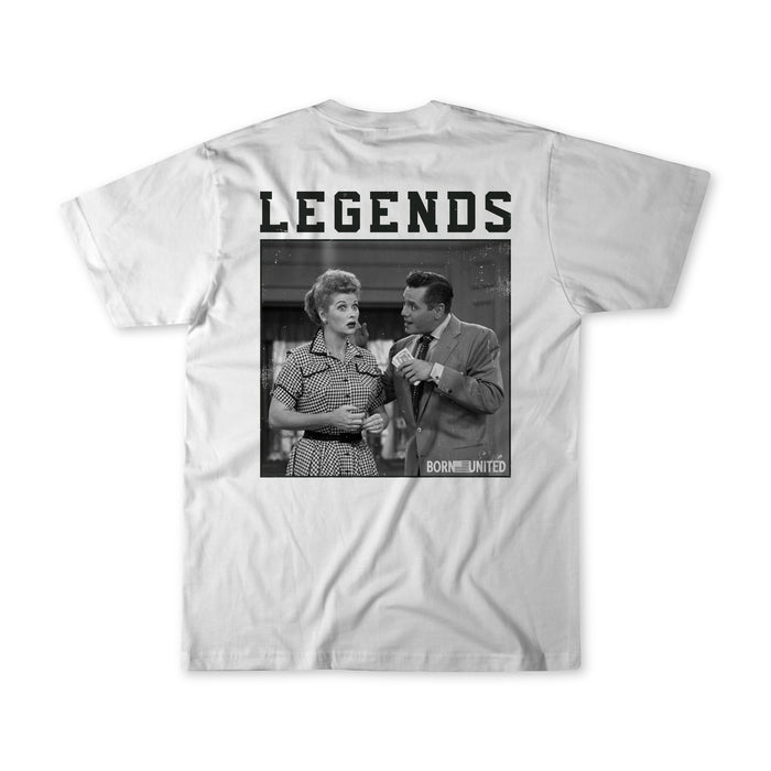 The Born United Private Label Legends - Honey Im Home! T-shirt features a black-and-white photo of a surprised woman and a man talking, with LEGENDS in bold above and BORN UNITED printed in the corner.