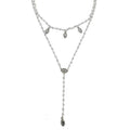 Silver beaded Y-necklace featuring eye and leaf charms.