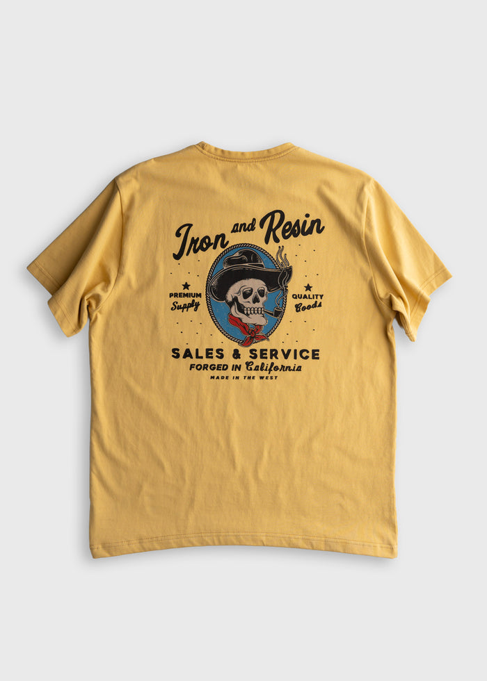 Yellow T-shirt with "Iron and Resin" logo featuring a skull in a hat, promoting premium supply and quality goods from California.