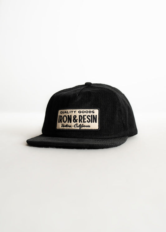 Black corduroy cap with "Iron & Resin" patch, reading "Quality Goods, Ventura, California," on a white background.