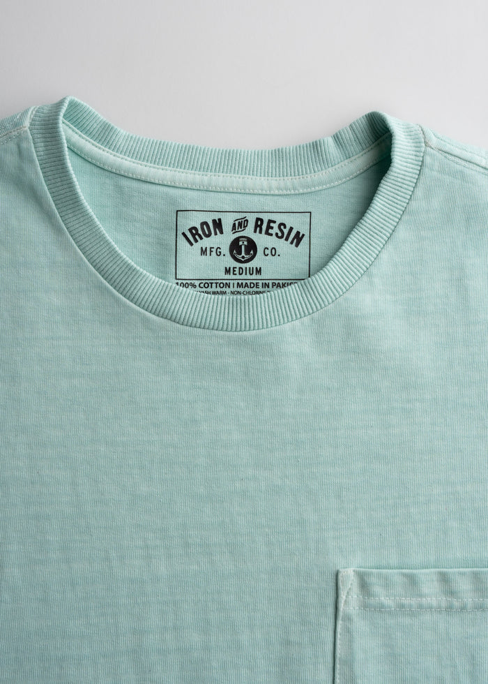 Close-up of men’s 10.25 oz heavyweight jersey cotton t-shirt in Aqua, detailing durable construction and soft feel