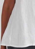 Weightless Tee, shown in White.  Zoomed in on the side panel detail, which gives you a smoother side and a slight flare to the shape.